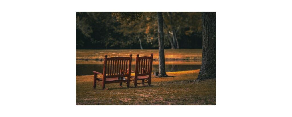 two chairs overlooking a lake